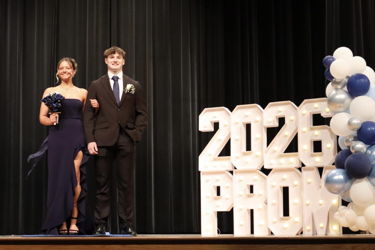 Lauren Dailey '27 escorted by date down the Blue Carpet