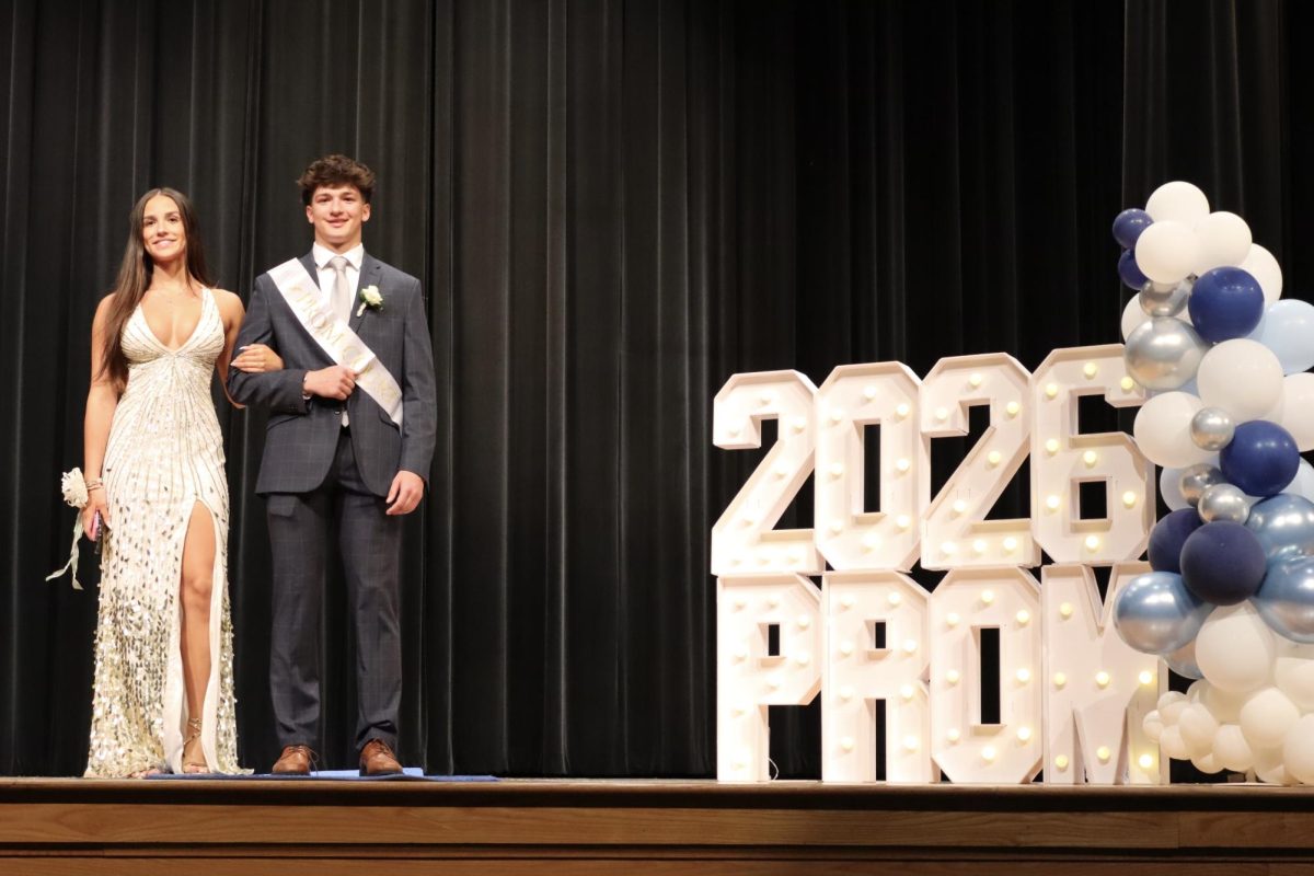 Brooke Balser '26 escorted by Sam Bernhardt '26 down the Blue Carpet 