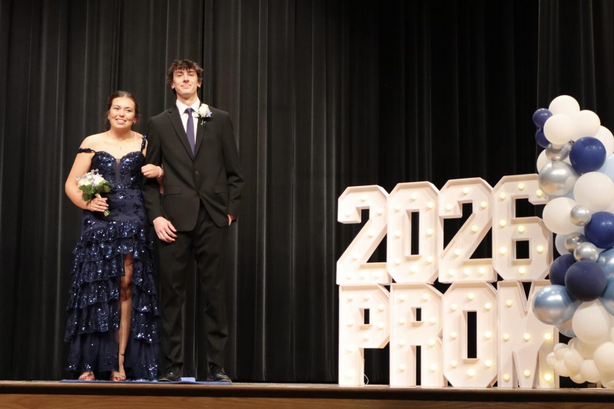 Addison Kolar '26 escorted by date down the Blue Carpet 