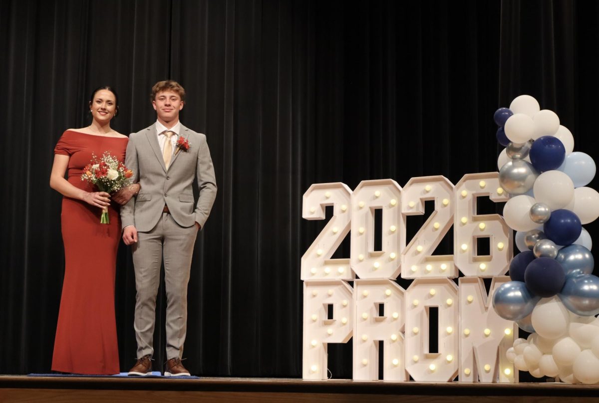 Allie Bohrer '26 escorted by date down the Blue Carpet 